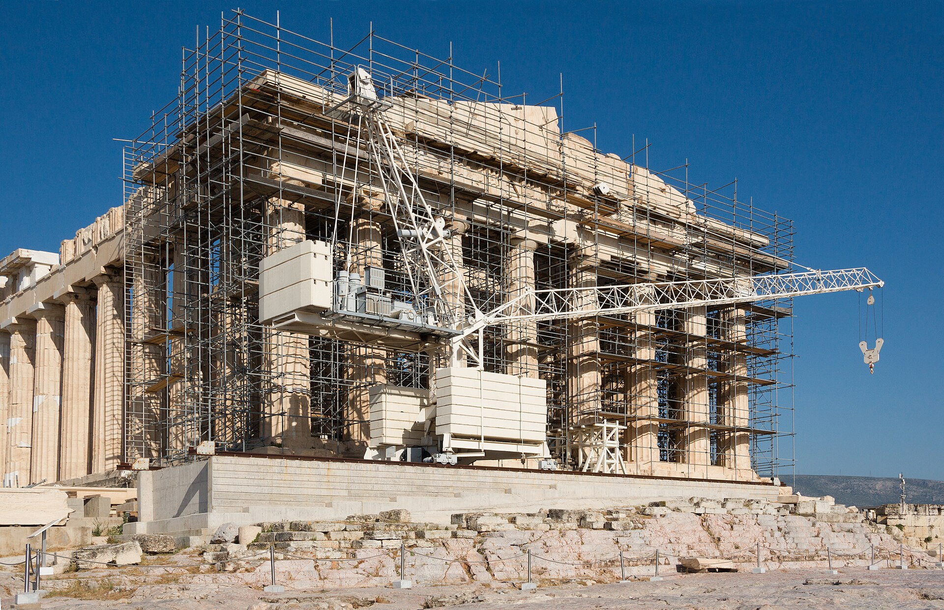 The Parthenon facade on the Acropolis of Athens under restoration scaffolding.