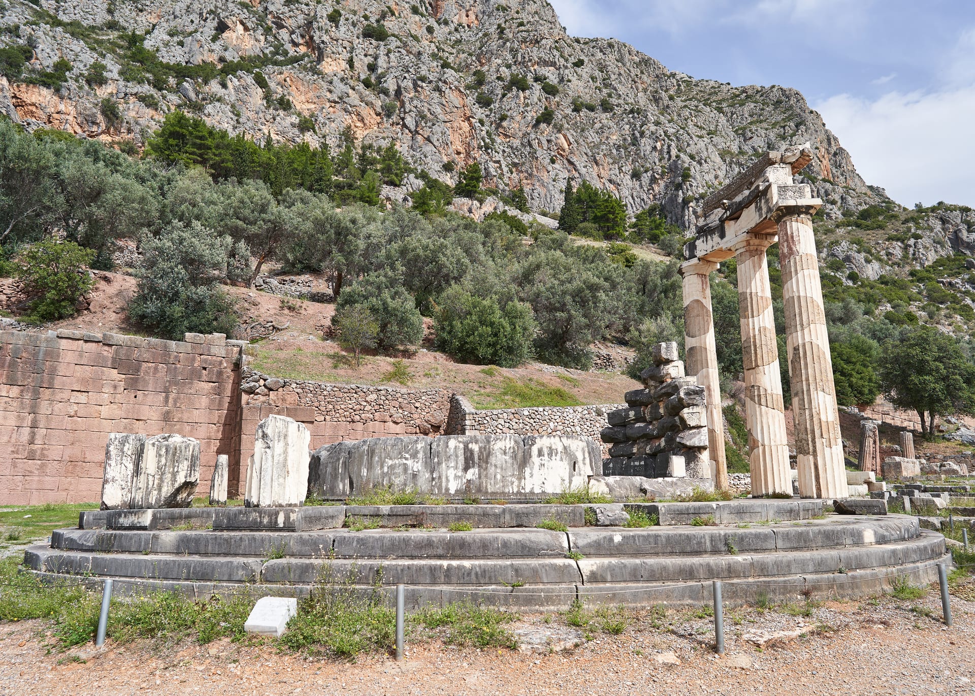 The reconstructed circular Tholos in the Sanctuary of Athena Pronaia at the Delphi archaeological site, below the slopes of Mount Parnassus.