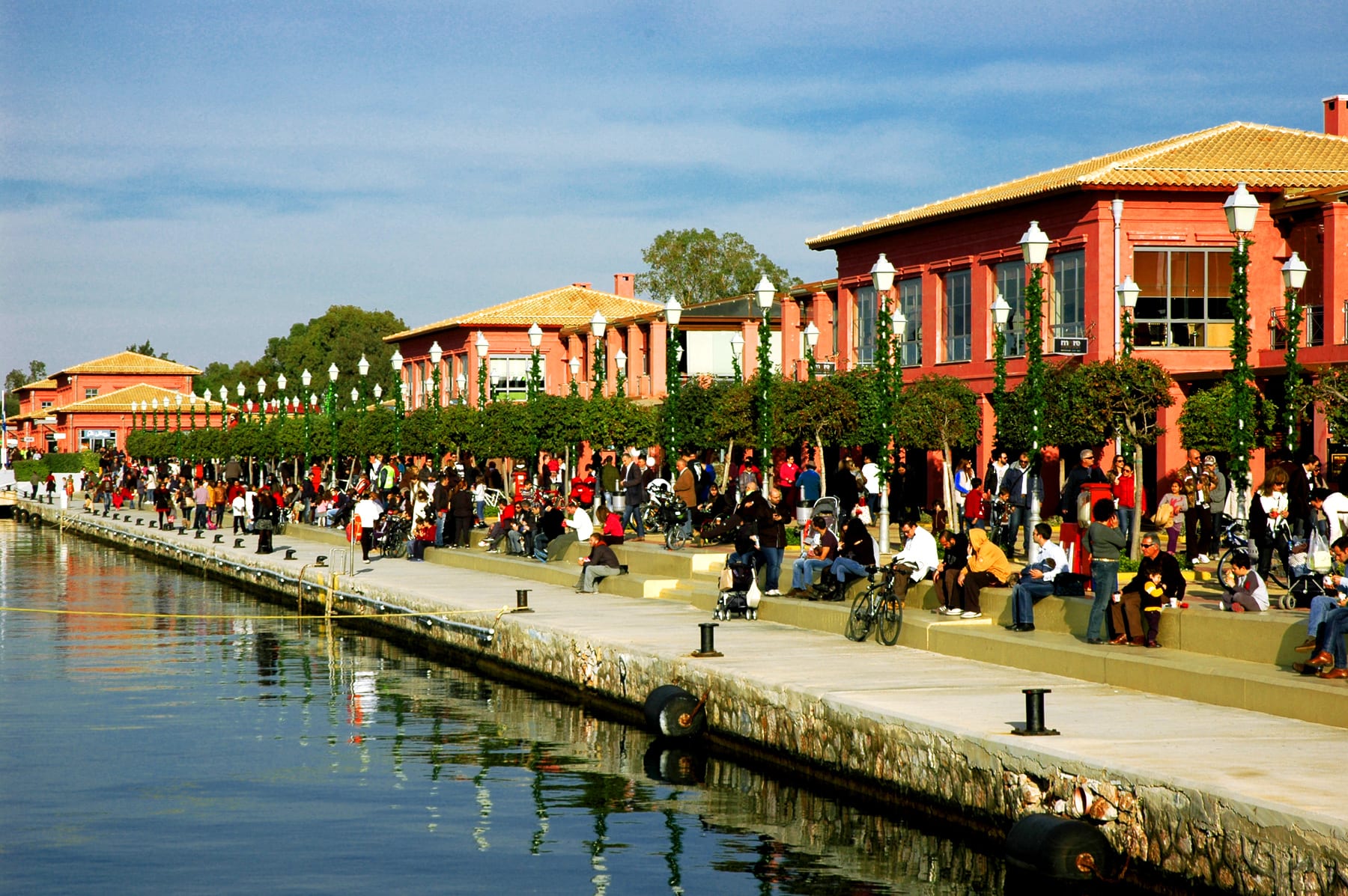 The waterfront promenade and red-roofed buildings of Flisvos Marina in Palaio Faliro, on the Athens coast.